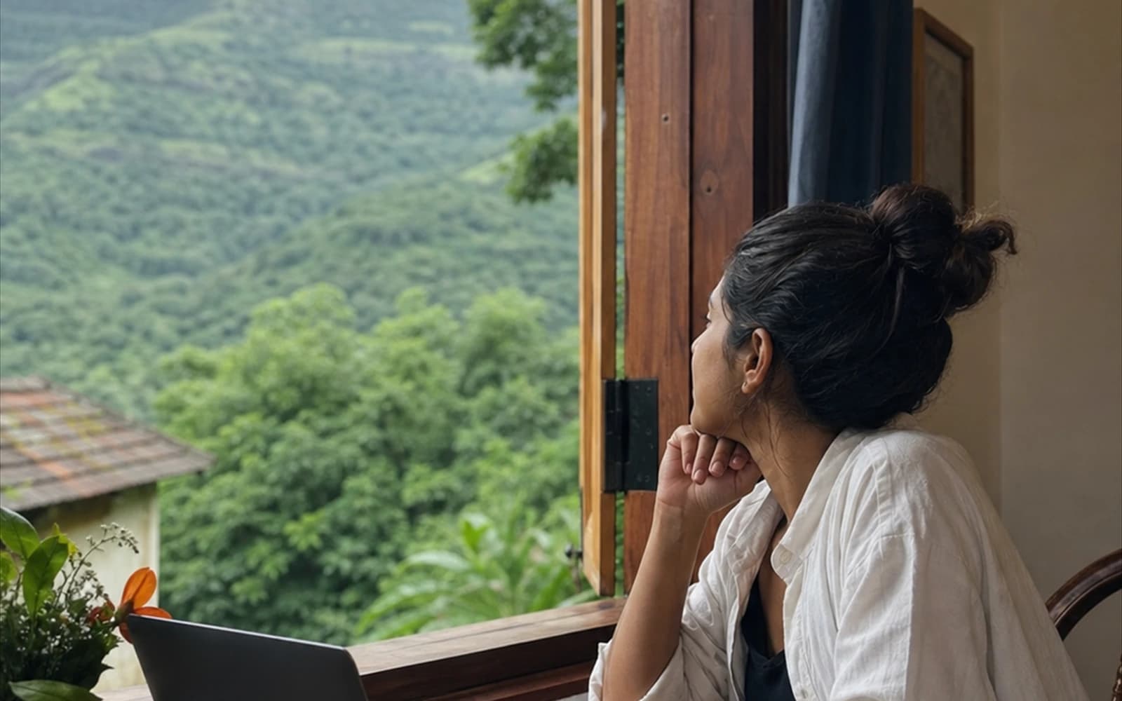 Traveller writing trip notes by a window